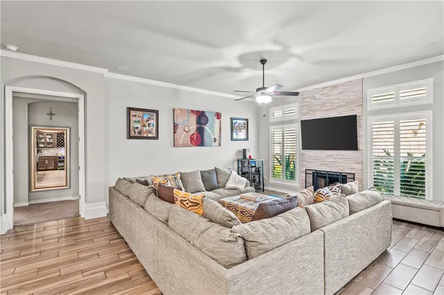 a living room with furniture fireplace and flat screen tv