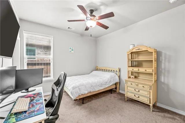 a bedroom with a bed and a desk