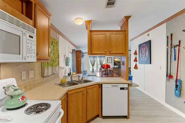 a kitchen with a sink stove and refrigerator