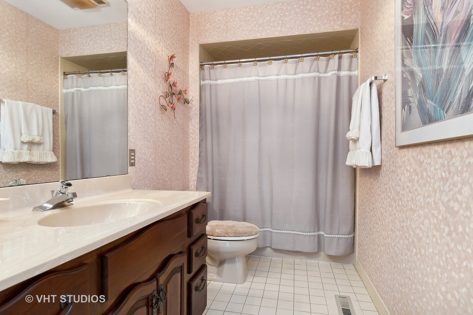 998 Landing Road Naperville, IL 60540 - Photo 15 of 18 a bathroom with a sink a toilet and a mirror