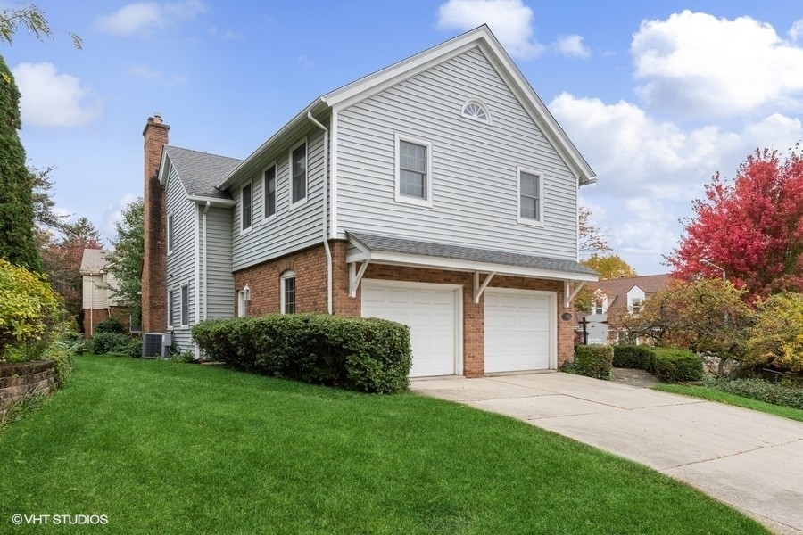 998 Landing Road Naperville, IL 60540 - Photo 17 of 18 a front view of a house with a garden and plants