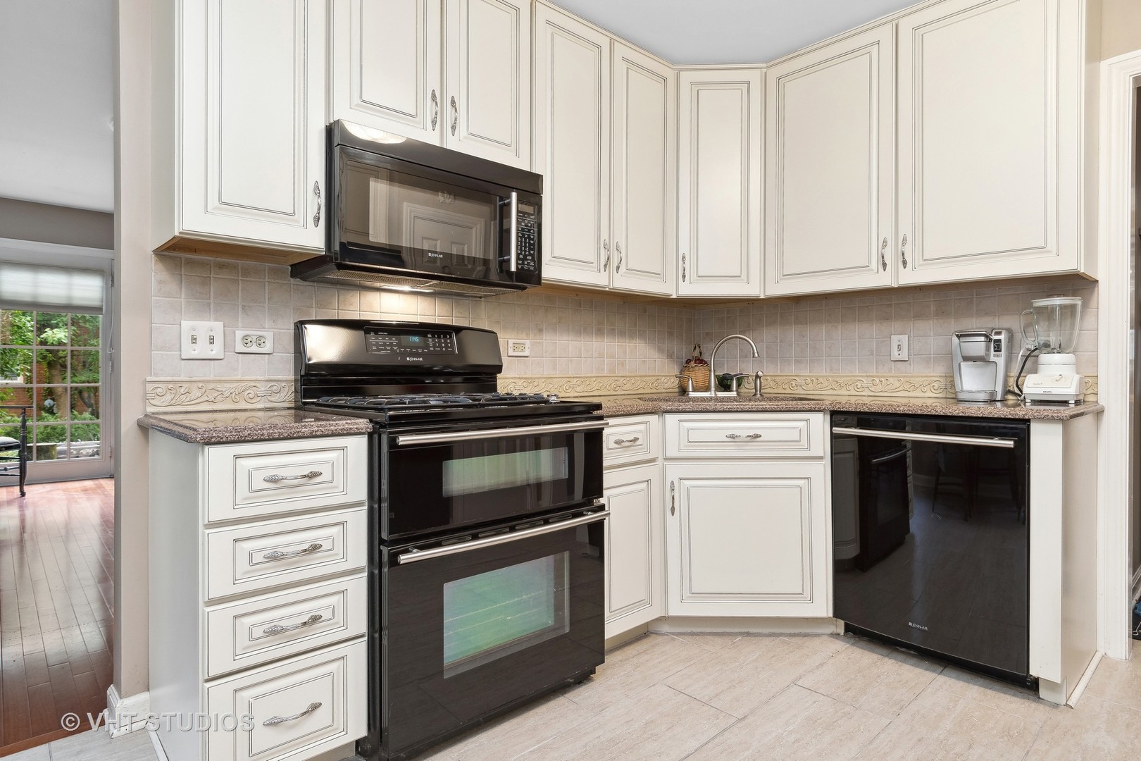 998 Landing Road Naperville, IL 60540 - Photo 5 of 18 a kitchen with granite countertop white cabinets and stainless steel appliances