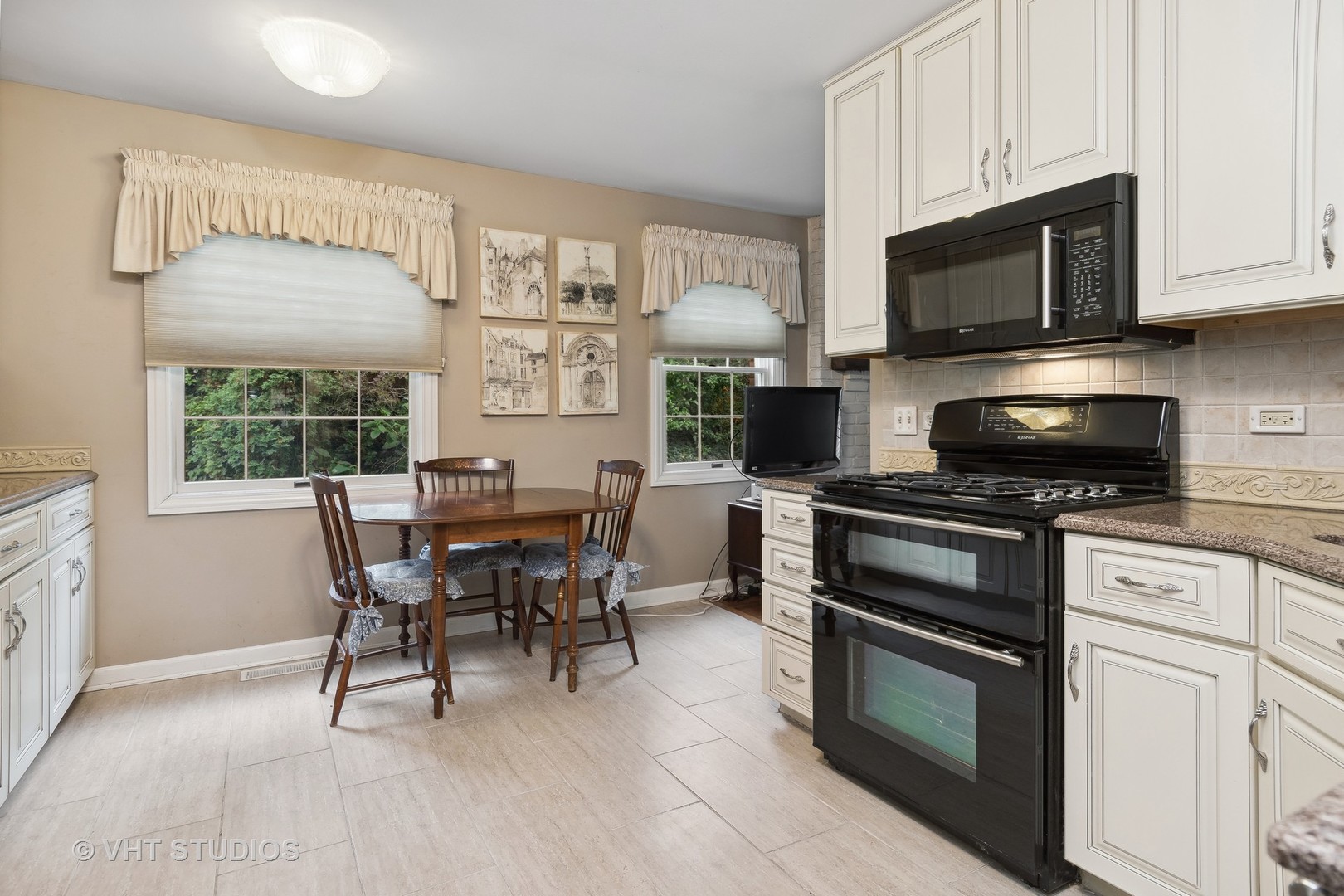 998 Landing Road Naperville, IL 60540 - Photo 7 of 18 a kitchen with stainless steel appliances white cabinets granite counter tops and a view of living room