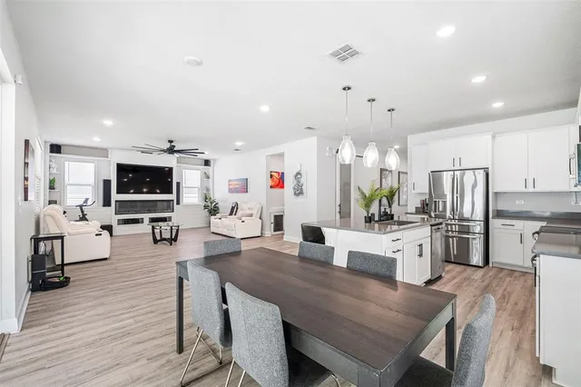 a large kitchen with a table and chairs