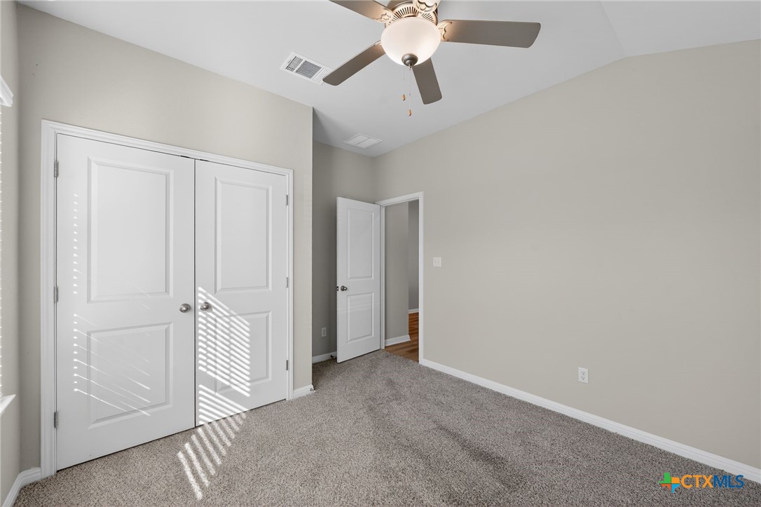 900 Main Street Hutto, TX 78634 - Photo 11 of 23 an empty room with a empty space and a ceiling fan