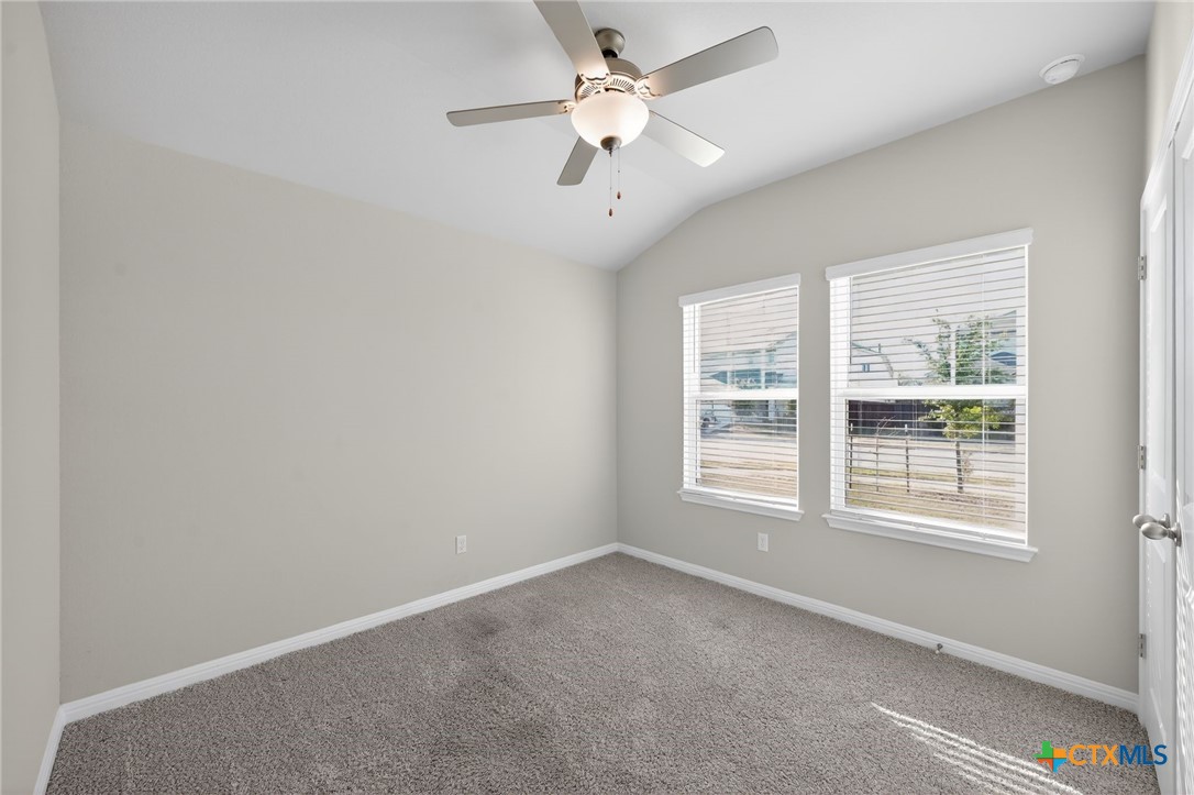 900 Main Street Hutto, TX 78634 - Photo 12 of 23 an empty room with a window and a fan