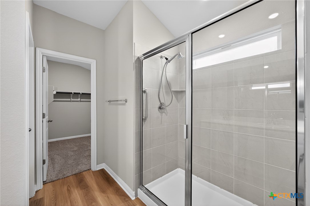 900 Main Street Hutto, TX 78634 - Photo 16 of 23 a bathroom with a glass shower door
