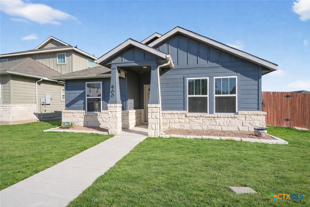 900 Main Street Hutto, TX 78634 - Photo 2 of 23 a front view of a house with a yard