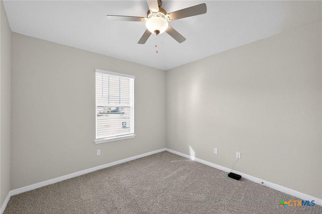 900 Main Street Hutto, TX 78634 - Photo 9 of 23 an empty room with windows and fan