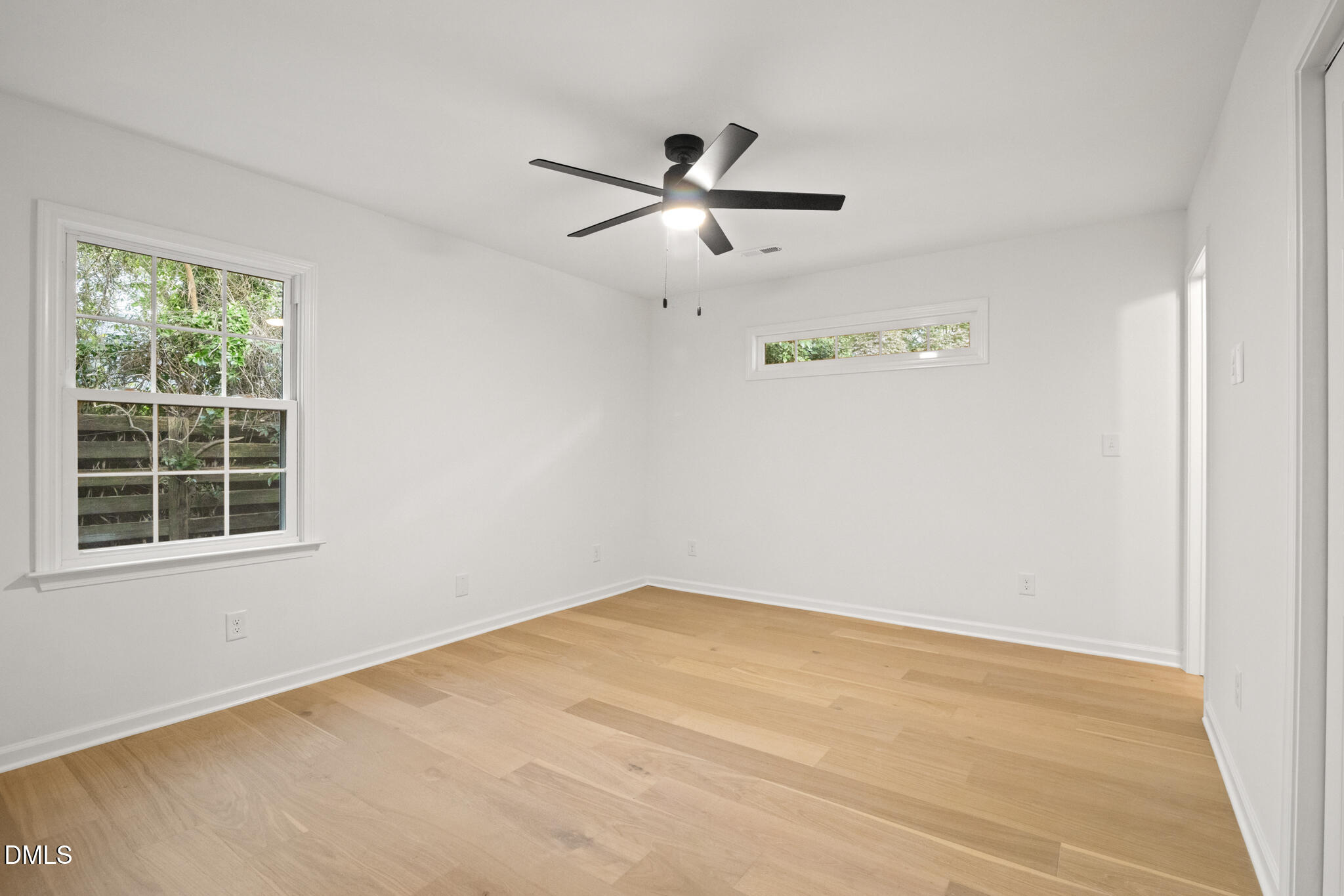 3509 Morningside Drive Raleigh, NC 27607 - Photo 26 of 49 an empty room with a window and a ceiling fan