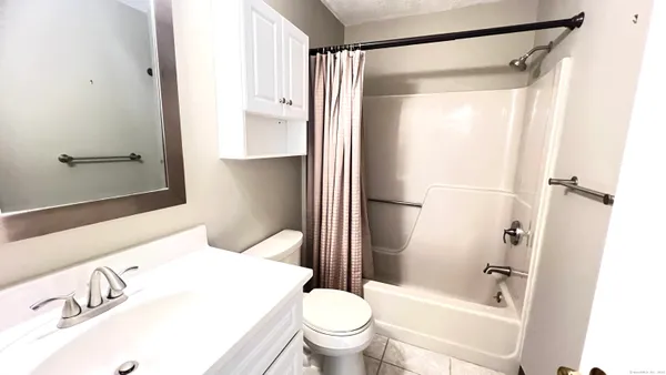 a bathroom with a shower and a toilet