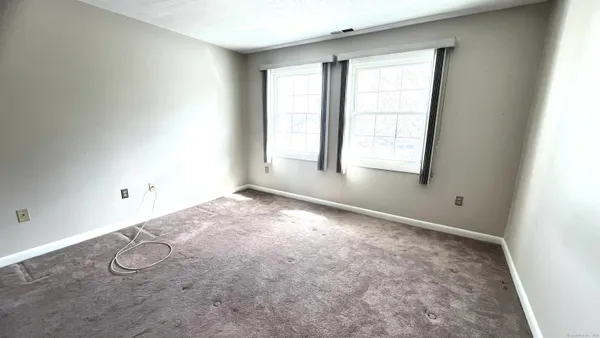 an empty room with a empty space and windows