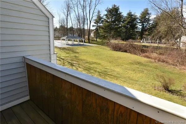 a view of a backyard with wooden fence