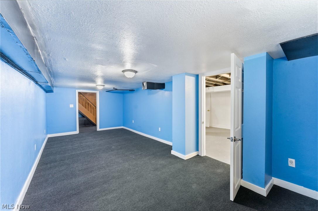 563 Geneva Avenue Struthers, OH 44471 - Photo 23 of 31 Unfurnished bedroom with a textured ceiling and dark carpet