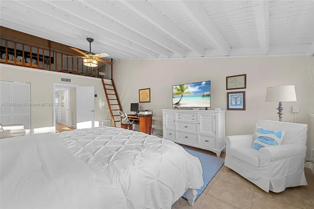 a bedroom with a bed a couch and dresser