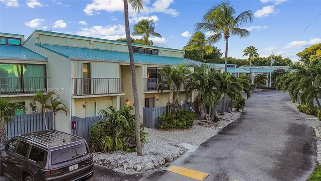 a view of backyard with plants and outdoor seating