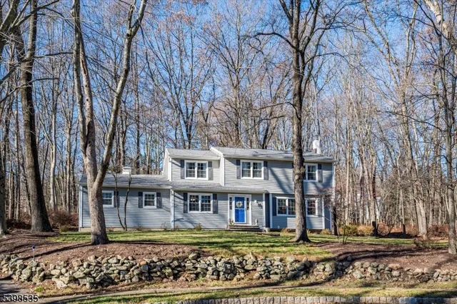 a backyard of a house with a yard and outdoor seating