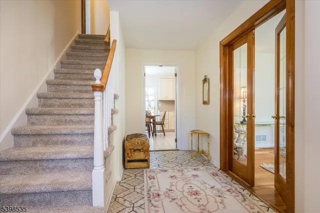 a living room with furniture and large windows