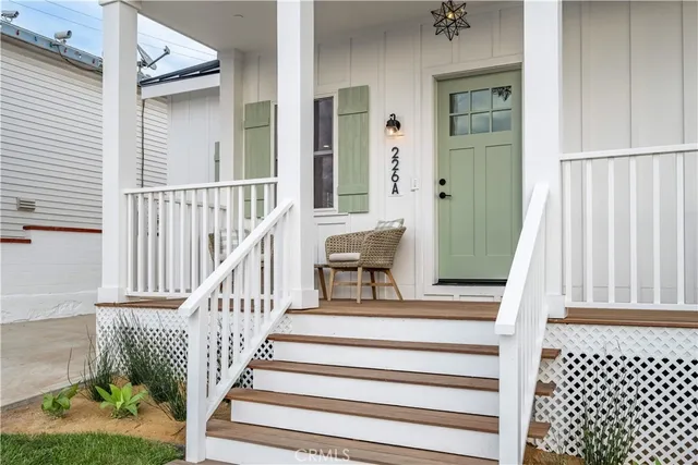 a view of entryway with wooden floor and front door