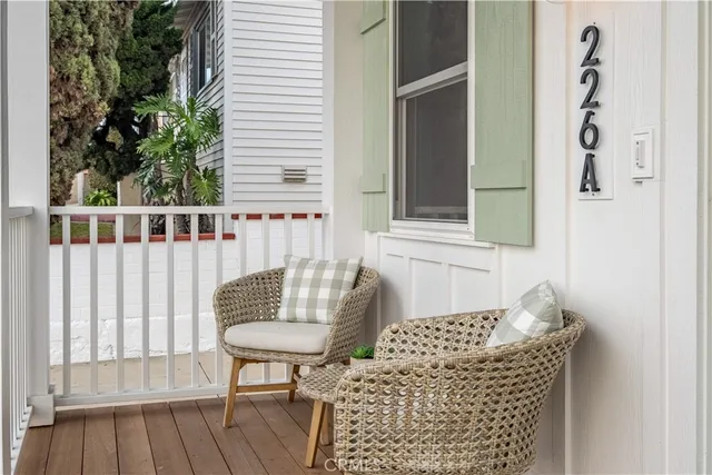 a view of balcony with wooden floor and outdoor seating