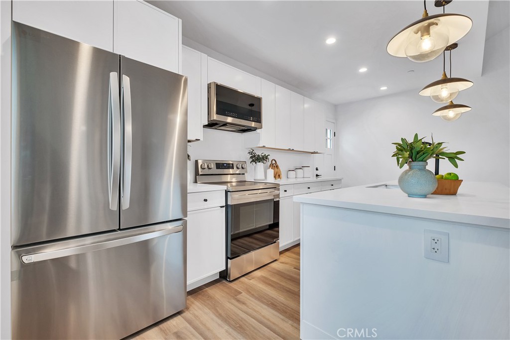 226 A Arena Street El Segundo, CA 90245 - Photo 31 of 47 a kitchen with stainless steel appliances a refrigerator sink and white cabinets