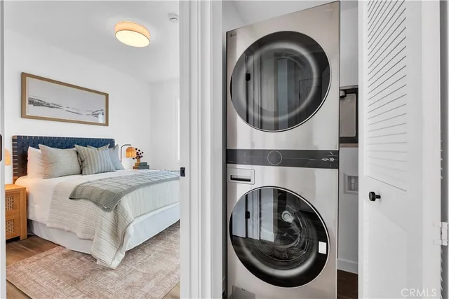 a view of a bedroom with washer and dryer