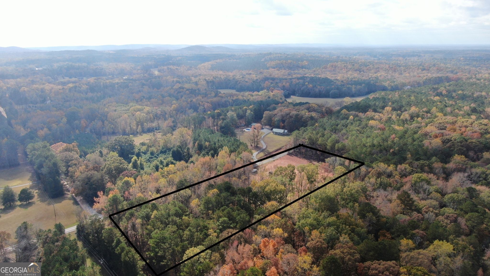 1880 Cook Road Zebulon, GA 30295 - Photo 4 of 8 an aerial view of a house with a yard and mountain view in back
