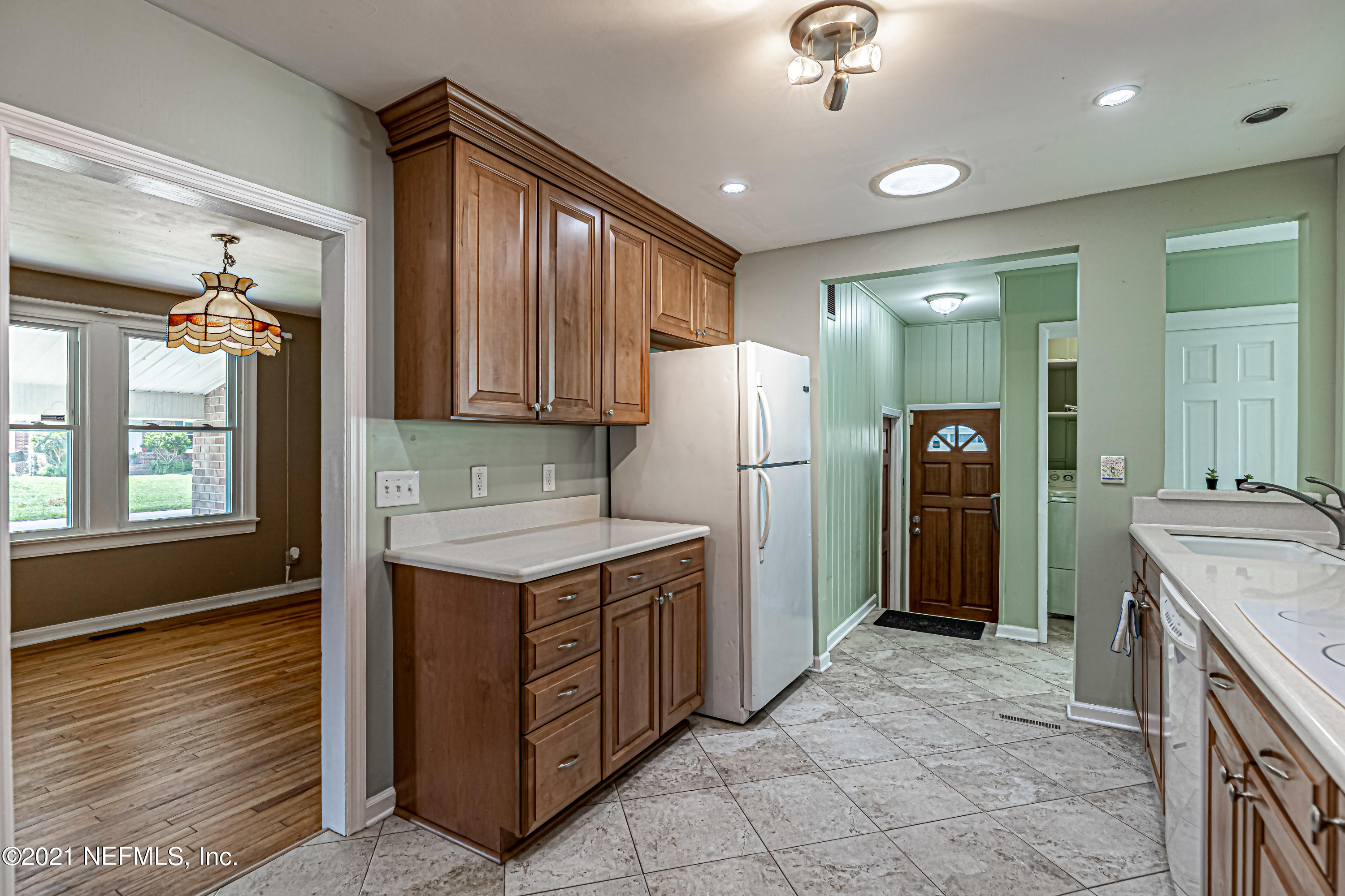 4627 Birkenhead Road Jacksonville, FL 32210 - Photo 14 of 30 a kitchen that has a sink a refrigerator and a stove