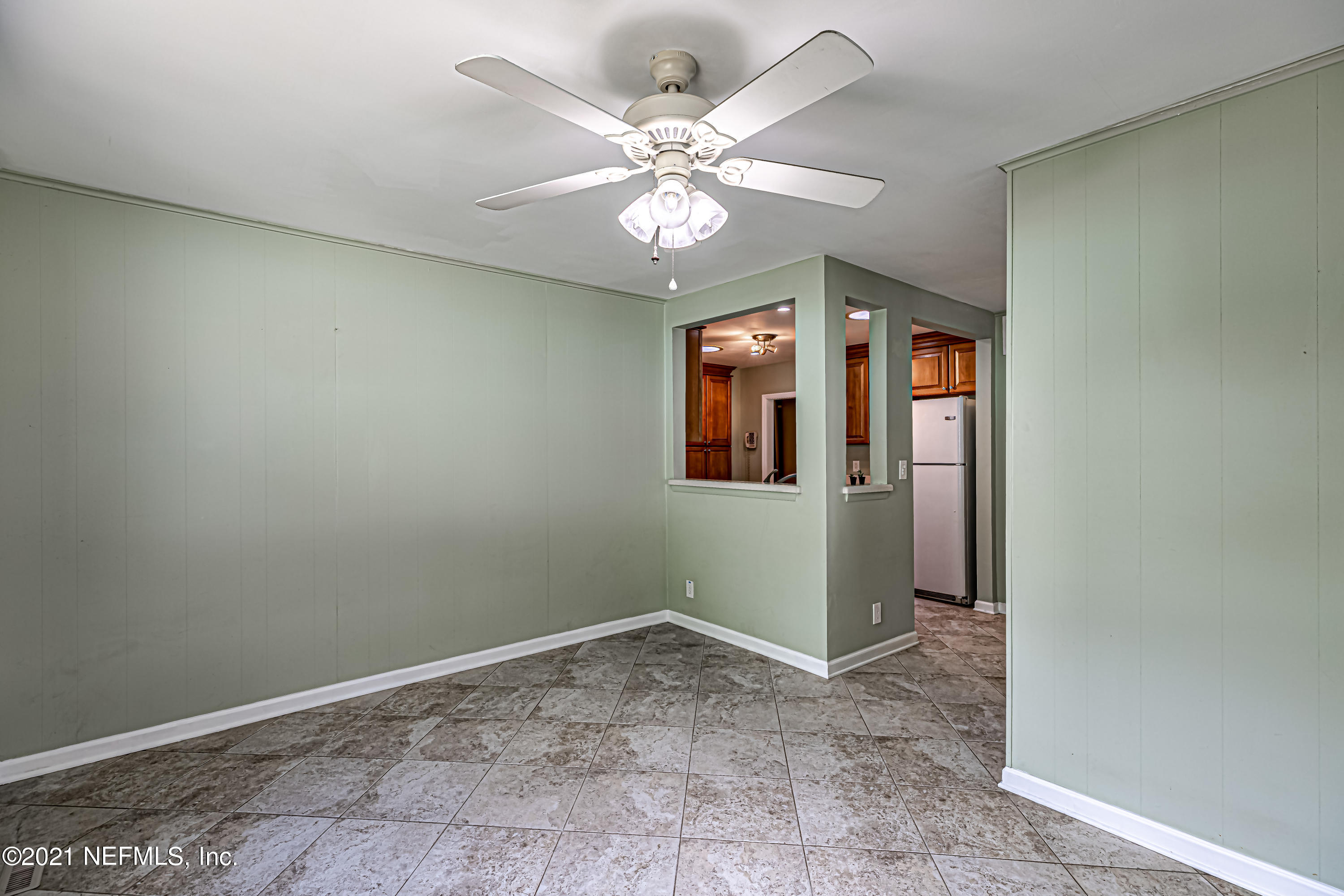 4627 Birkenhead Road Jacksonville, FL 32210 - Photo 16 of 30 an empty room with windows and ceiling fan