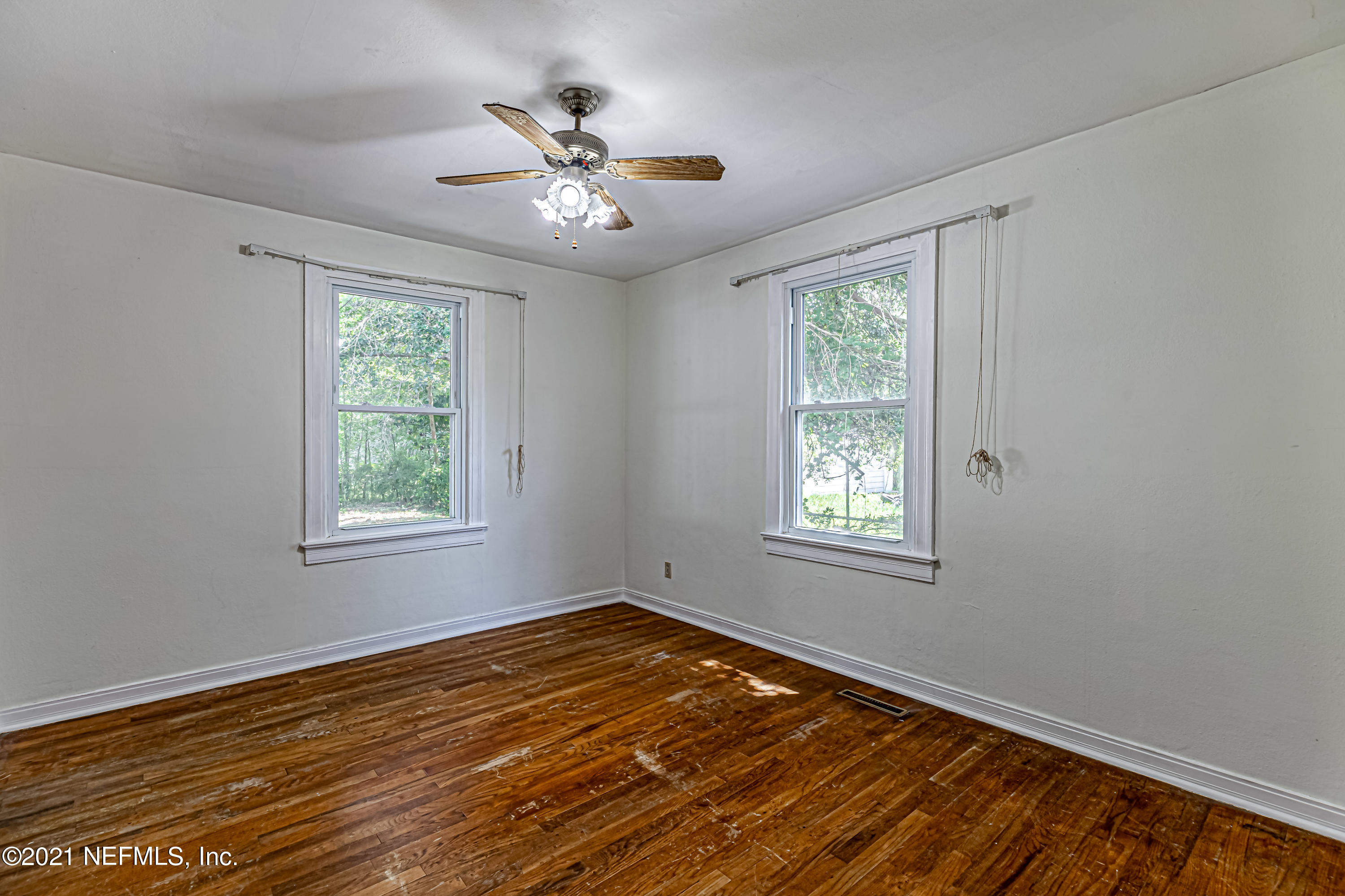 4627 Birkenhead Road Jacksonville, FL 32210 - Photo 19 of 30 a view of an empty room with wooden floor and a window