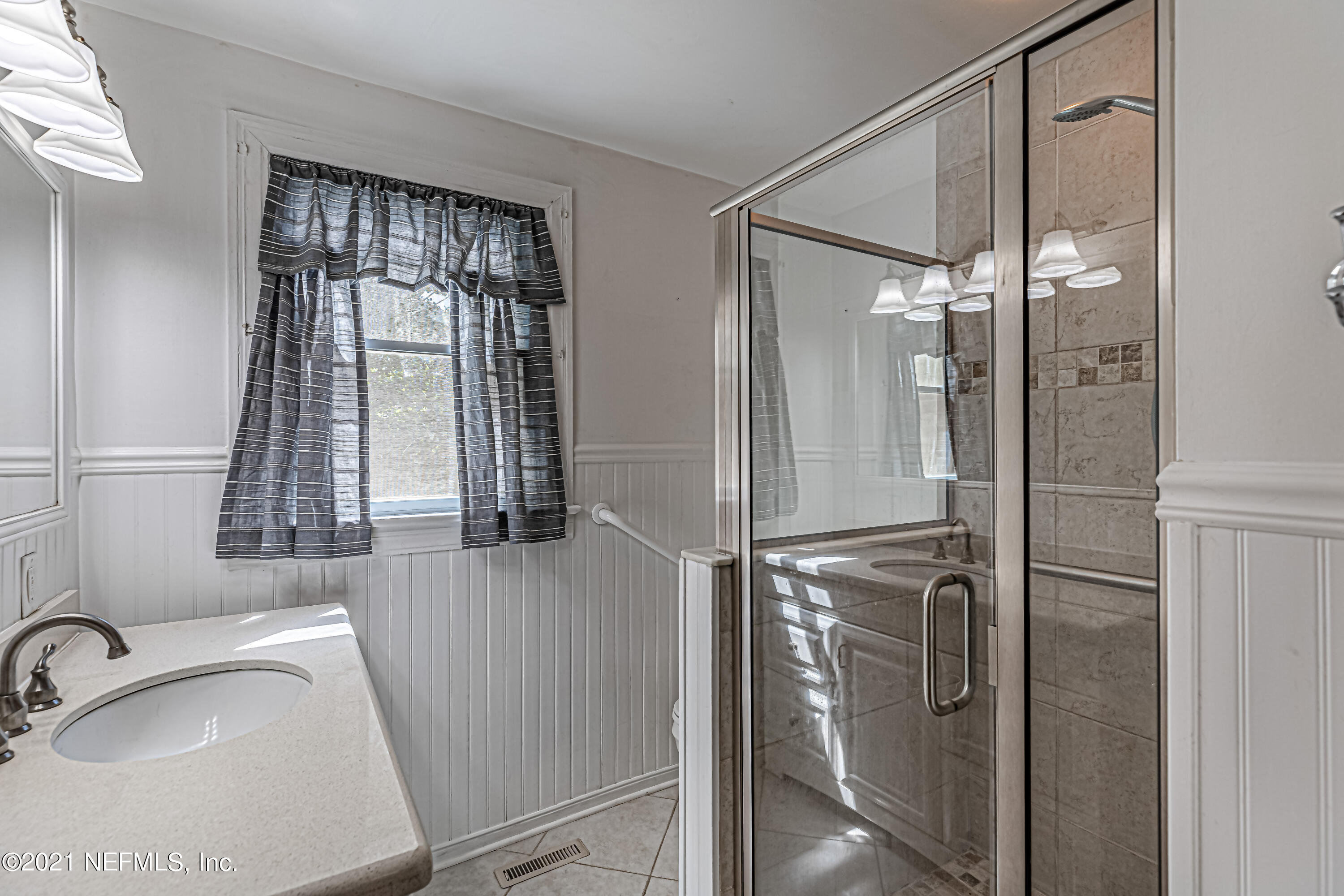 4627 Birkenhead Road Jacksonville, FL 32210 - Photo 21 of 30 a bathroom with a sink shower and a mirror