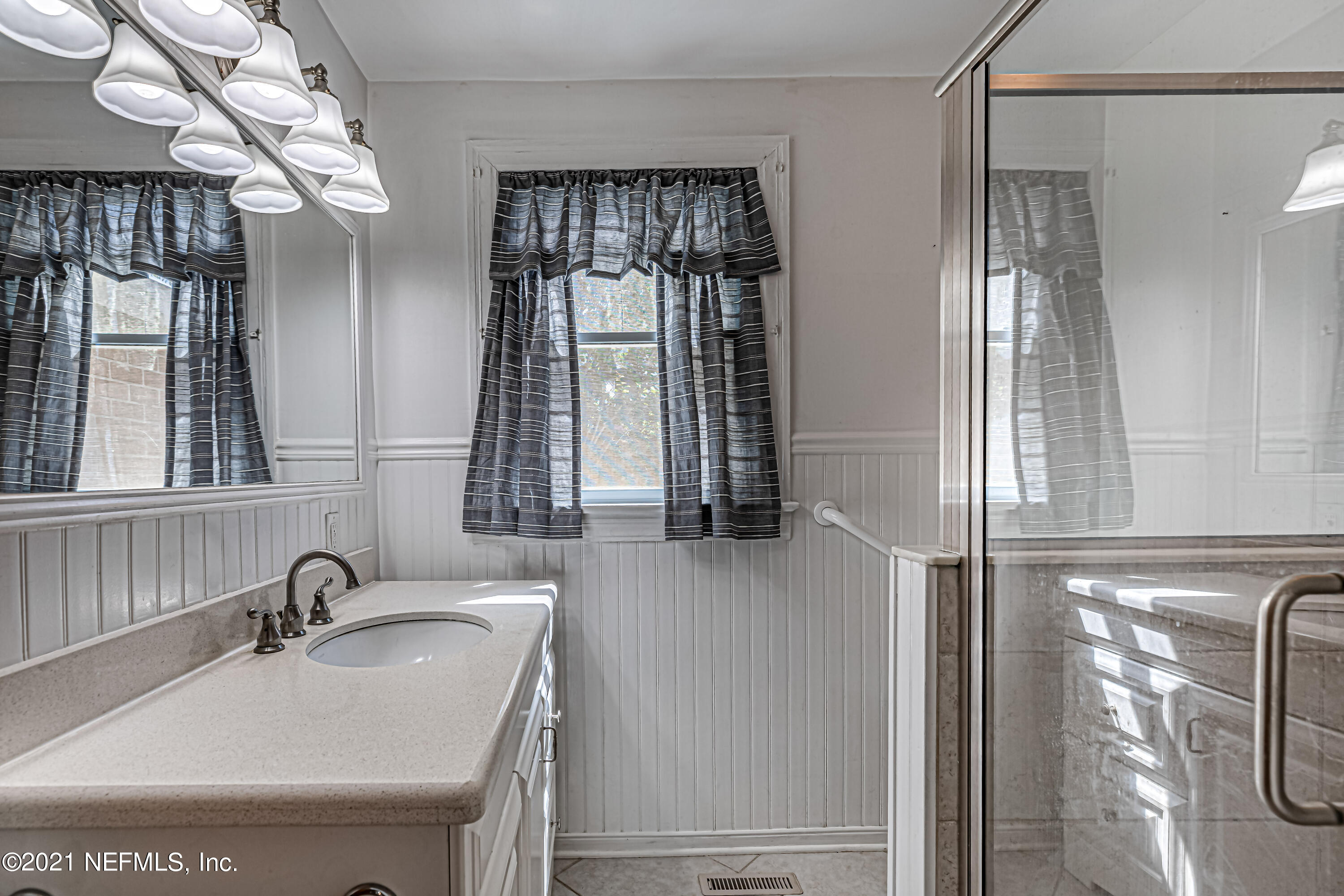 4627 Birkenhead Road Jacksonville, FL 32210 - Photo 22 of 30 a bathroom with a sink a vanity and a mirror