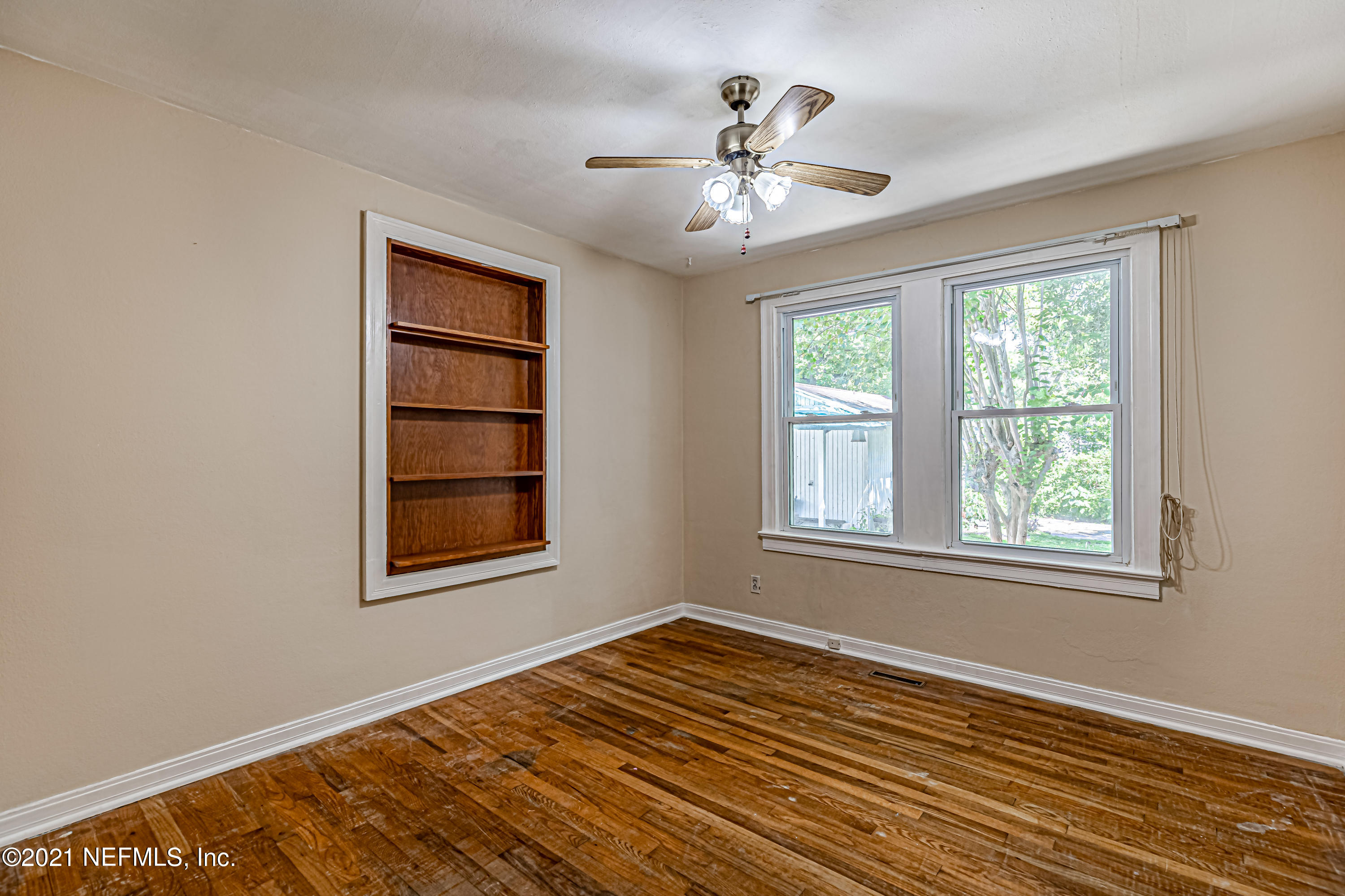 4627 Birkenhead Road Jacksonville, FL 32210 - Photo 23 of 30 a view of an empty room with a window and wooden floor