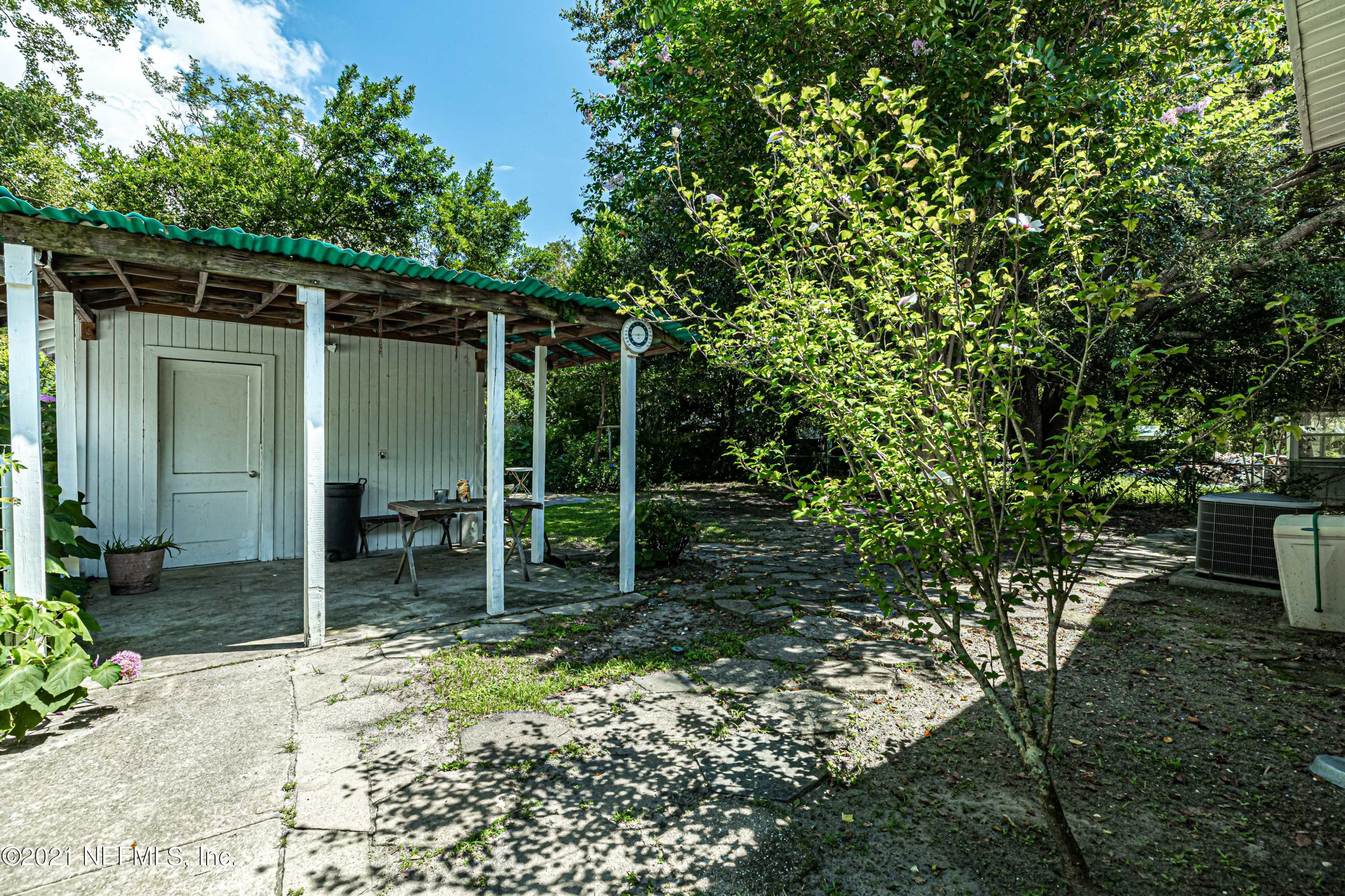 4627 Birkenhead Road Jacksonville, FL 32210 - Photo 26 of 30 a backyard of a house with table and chairs