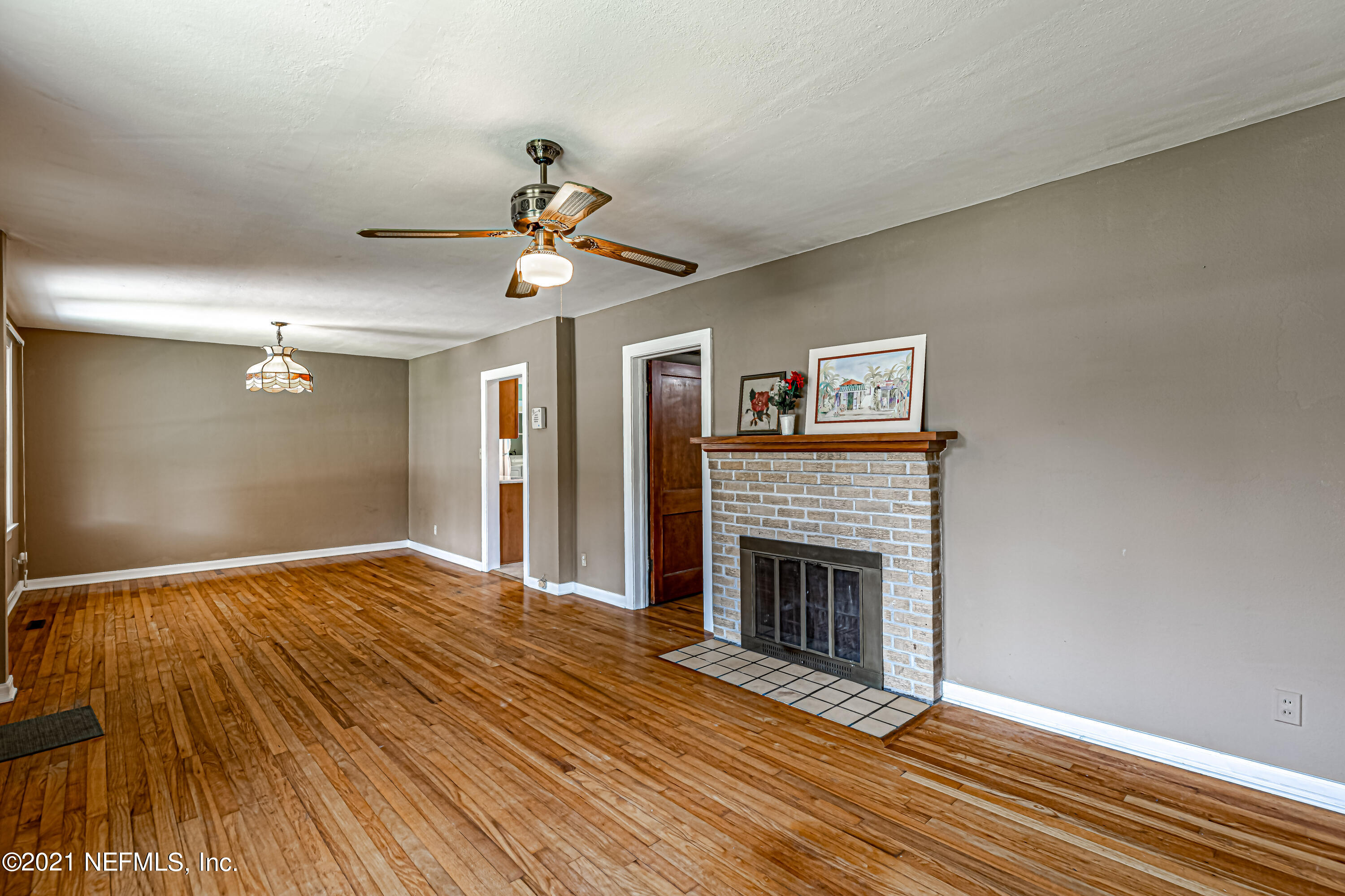 4627 Birkenhead Road Jacksonville, FL 32210 - Photo 10 of 30 a view of empty room with wooden floor and fireplace