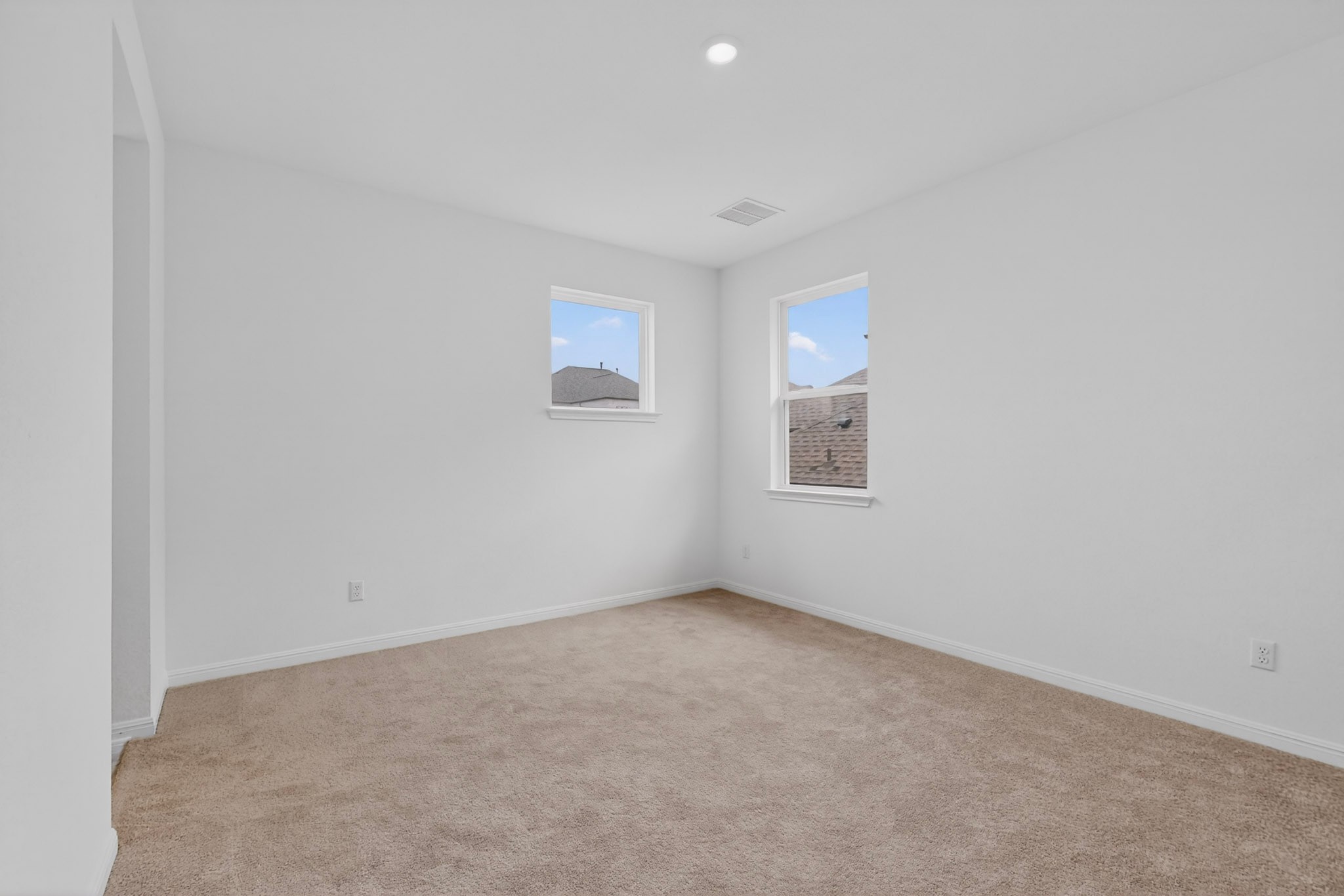 2308 Mondello Path Leander, TX 78641 - Photo 28 of 39 A quiet secondary bedroom offers serene views and soft carpeting, creating a peaceful retreat.