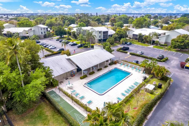 an aerial view of a house with a garden and swimming pool