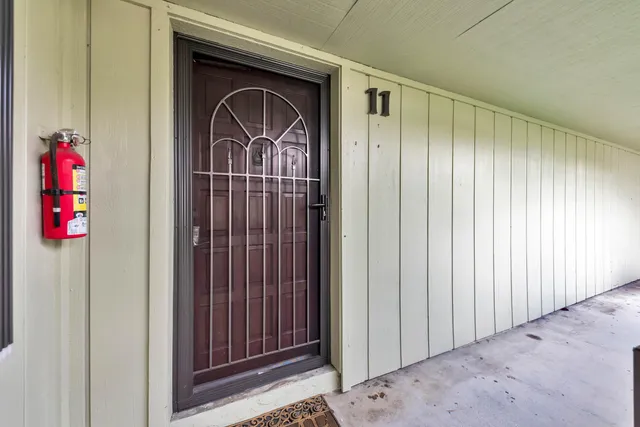 a view of a kitchen with furniture and an entryway