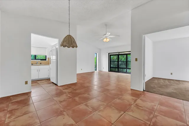 a view of empty room with a ceiling fan