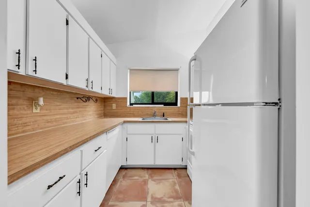 a kitchen with appliances cabinets and a sink