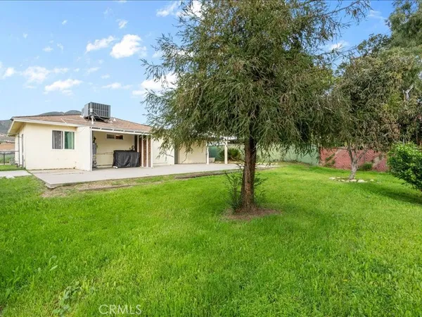 a view of an house with backyard space and garden