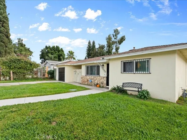 a front view of house with a garden and patio