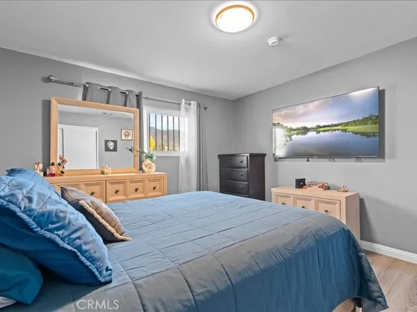 a bedroom with a bed and large windows