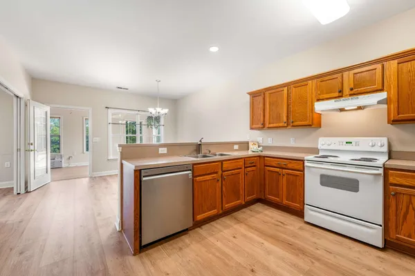 a kitchen with sink cabinets and wooden floor