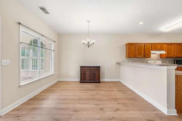 a view of a kitchen with a dishwasher and wooden floor