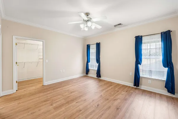 a view of an empty room with wooden floor