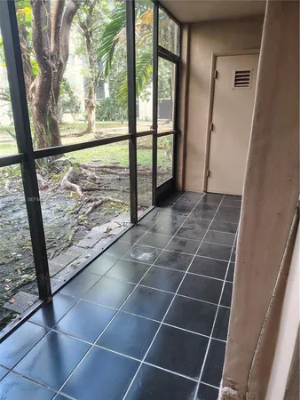 a view of a room with wooden floor and door