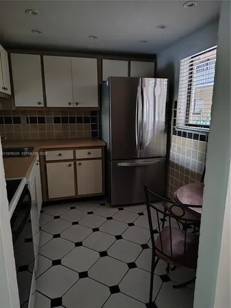 a kitchen with stainless steel appliances a refrigerator sink and cabinets