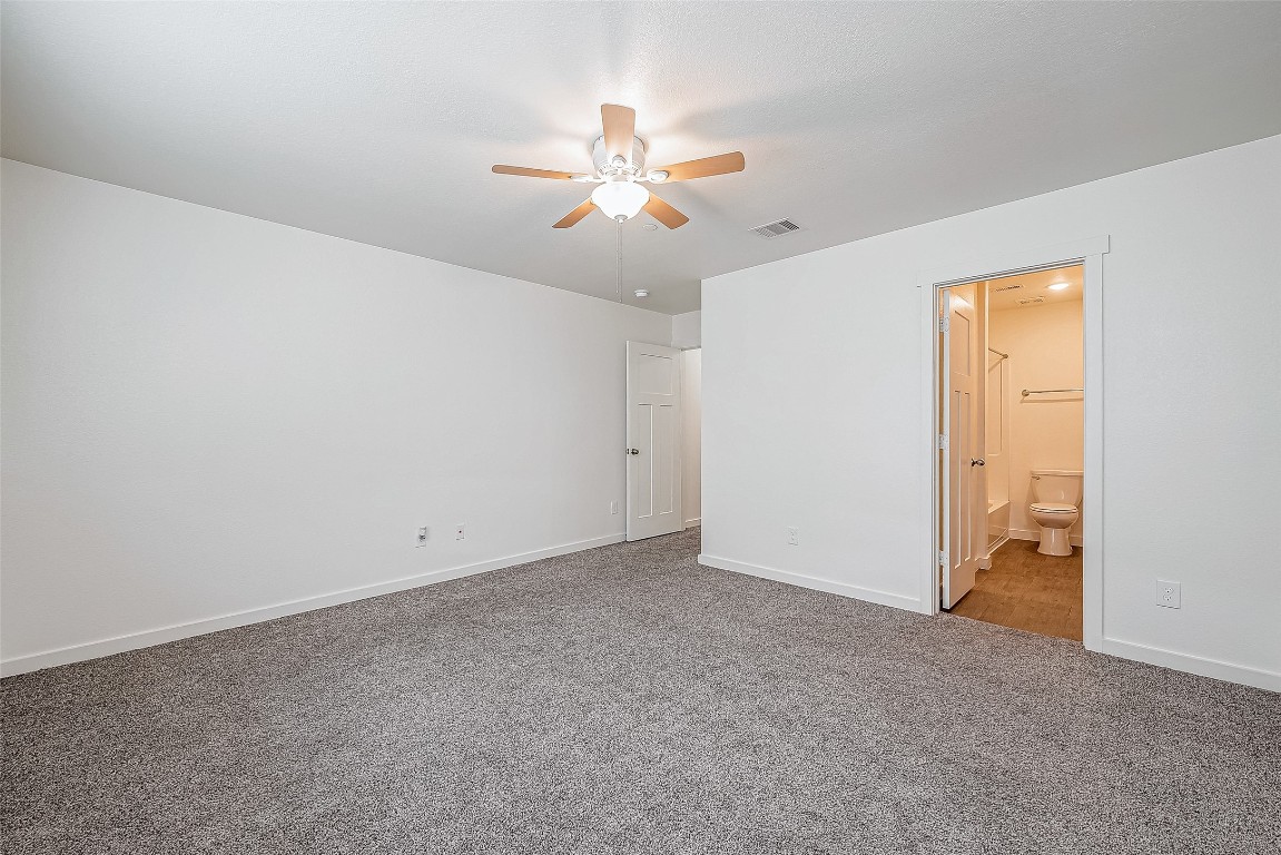 21155 Gosling Road, Unit 15 AB Spring, TX 77388 - Photo 15 of 30 This room features neutral carpeting, a ceiling fan with light, and a window with blinds, creating a bright and comfortable space.
