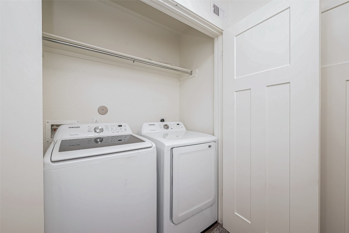 21155 Gosling Road, Unit 15 AB Spring, TX 77388 - Photo 19 of 30 This photo shows a compact laundry closet featuring a washer and dryer set,